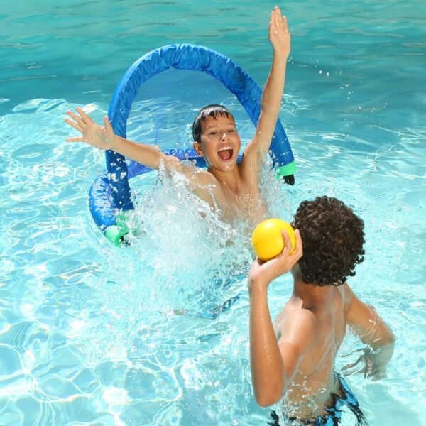 Two children playing in a pool, one splashing while the other holds a yellow ball, creating a joyful, sunny atmosphere.