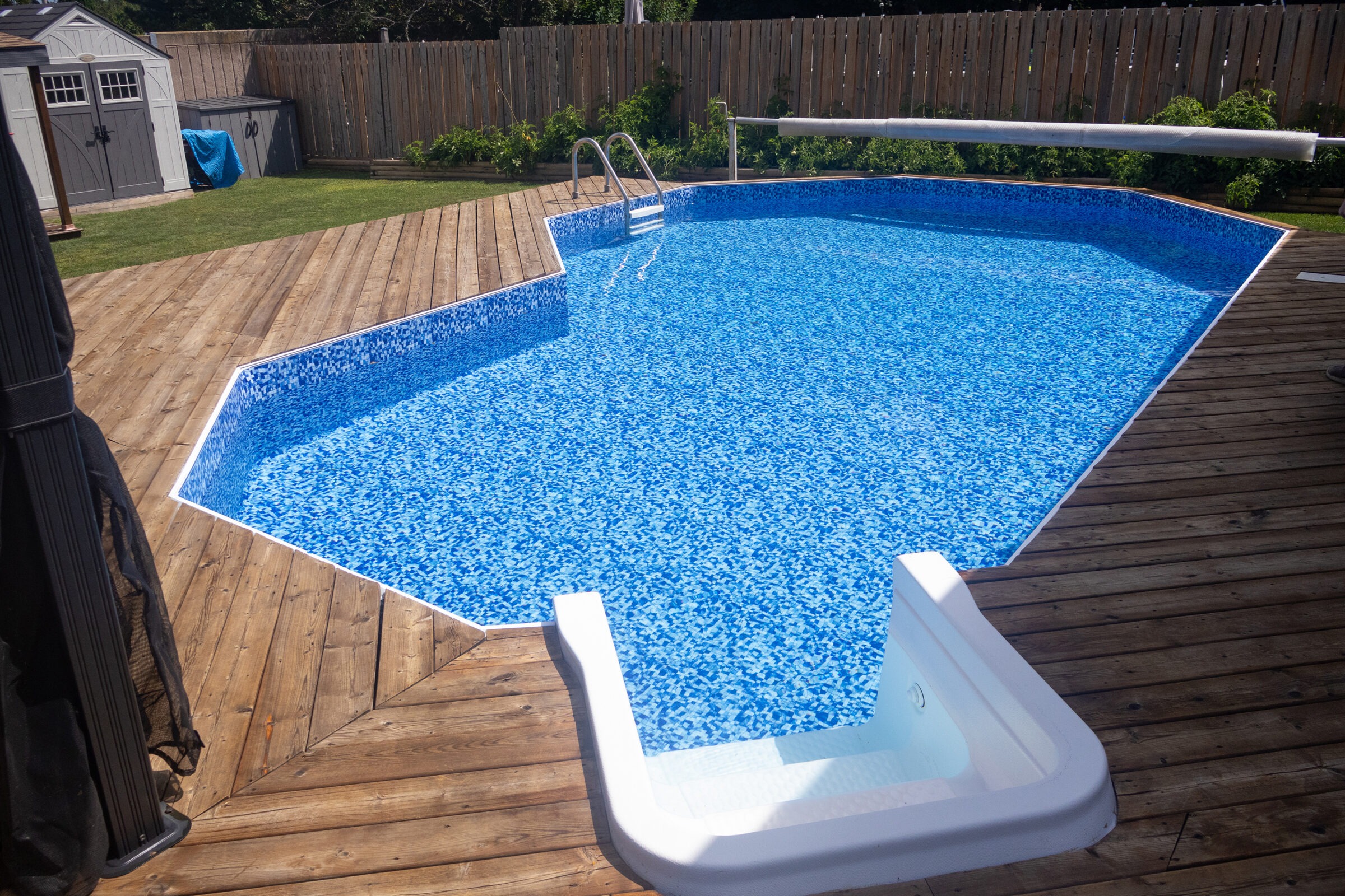 A backyard features an above-ground pool with blue water, wooden deck, slide, and a small garden. A shed is visible in the background.