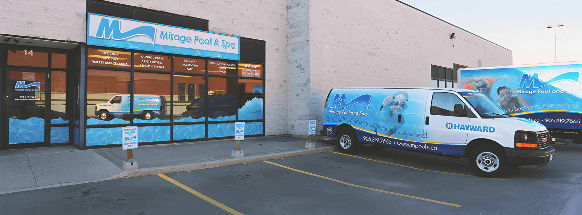 Storefront of Mirage Pool & Spa with branded vans parked outside, located in a commercial area with clear signage and parking spaces.